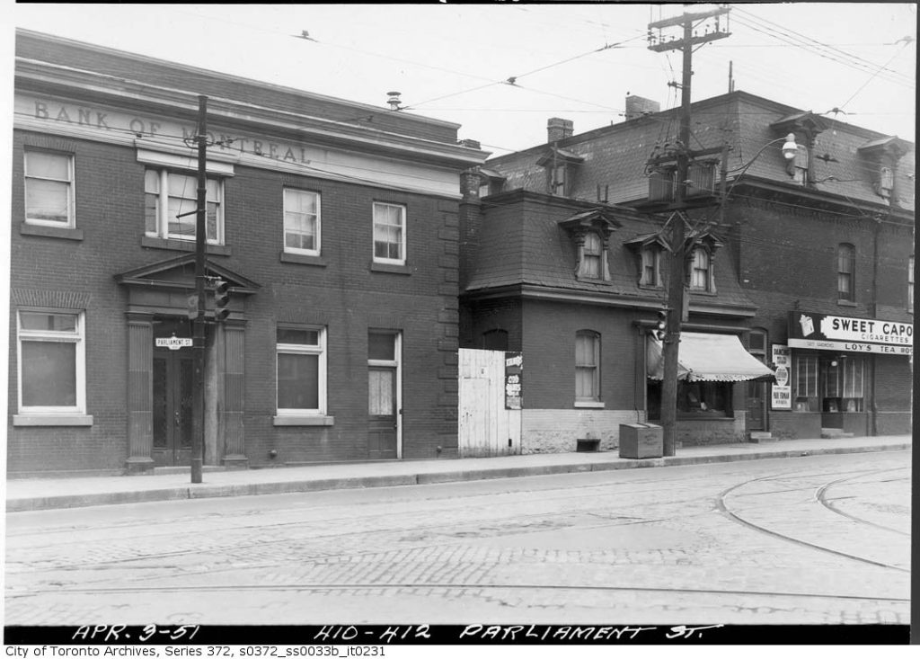 Image of Bank of Montreal building and others with a traffic light on Parliament Street